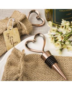 Heart shaped metal bottle stopper in a Copper plated finish in a burlap bag